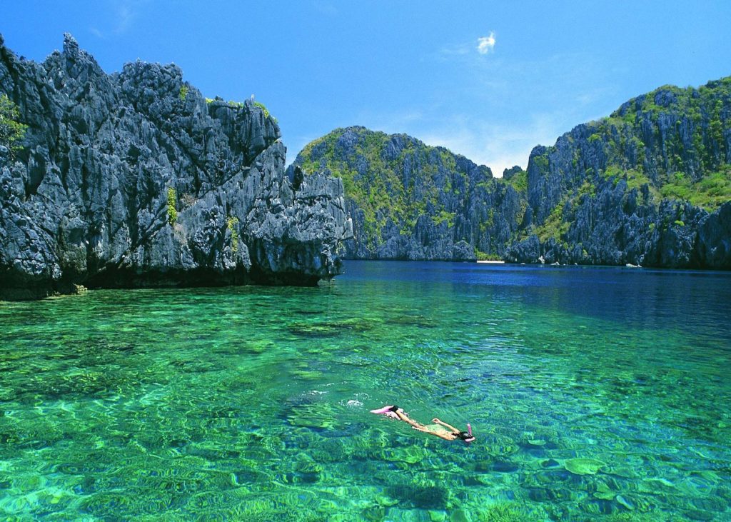 snorkelling in the crystal clear waters of El Nido